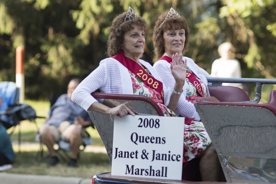 Former Festival Queens Janet and Janice Marshall make their way down the parade route during the Twins Days Festival in Twinsberg, Ohio on Saturday. Photo by Dustin Franz