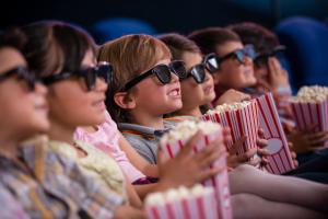 Group of children at the cinema watching a 3D movie
